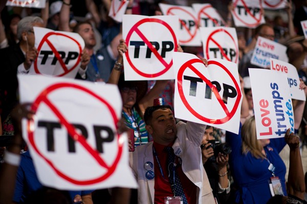 Delegates supporting Bernie Sanders wave anti-TPP signs at the Democratic National Convention, Philadelphia, July 25, 2016 (CQ Roll Call photo by Bill Clark via AP).