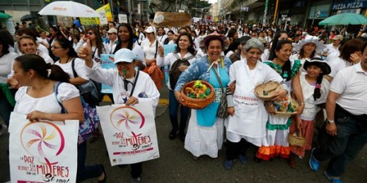 People march to protest physical abuse of women and in support of Colombia's peace talks with the FARC, Bogota, Colombia, Nov. 22, 2013 (AP photo by Fernando Vergara).