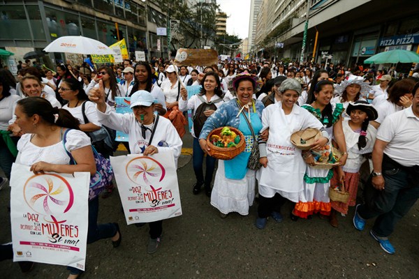 People march to protest physical abuse of women and in support of Colombia's peace talks with the FARC, Bogota, Colombia, Nov. 22, 2013 (AP photo by Fernando Vergara).