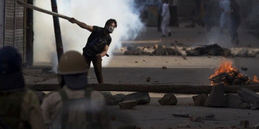 A Kashmiri protester clashes with Indian policemen during a protest, Srinagar, Indian-controlled Kashmir, Aug. 9, 2016 (AP photo by Dar Yasin).