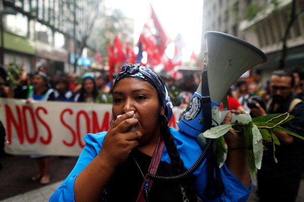 A Mapuche indigenous woman shouts slogans during a march commemorating the police killing of an activist, Santiago, Chile, Jan. 5, 2016 (AP photo by Luis Hidalgo).