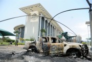 Burnt-out cars outside a government building following an election protest in Libreville, Gabon, Sept. 1, 2016 (AP photo by Joel Bouopda).