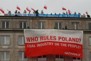 Climate activists protest on the rooftop of the Economy Ministry, Warsaw, Poland, Nov. 18, 2013 (AP photo by Czarek Sokolowski).
