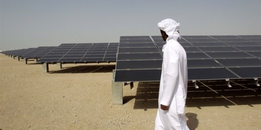 An Emirati man walks by a photovoltaic plant at Masdar City, Abu Dhabi, United Arab Emirates, Jan. 16, 2011 (AP photo by Kamran Jebreili).