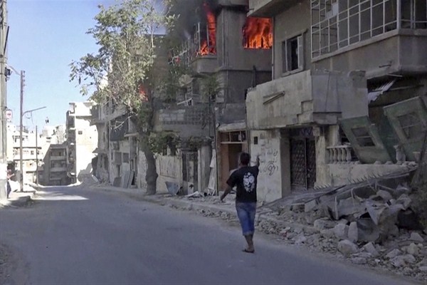 Still frame from video provided by Doctors Without Borders shows a house on fire in Aleppo, Syria, Oct. 5, 2016 (Doctors Without Borders via AP).