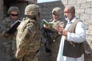 A member of the Civilian Expeditionary Workforce talks to a local business owner, Kandahar Province, Mar. 13, 2013 (Kentucky National Guard photo by Lt. Col. Dallas Kratzer).