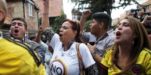 Opponents of the peace deal signed between the Colombian government and FARC rebels celebrate the results of the referendum on the peace accord, Bogota, Colombia, Oct. 2, 2016 (AP photo by Ariana Cubillos).