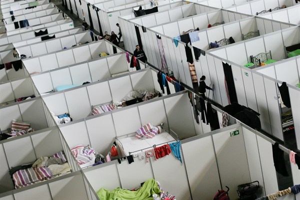 Cabins inside a hangar are used as a temporary emergency shelter for asylum-seekers, Berlin, Germany, Dec. 9, 2015 (AP photo by Markus Schreiber).