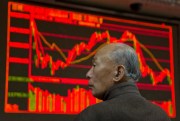 A Chinese investor monitors prices at a brokerage, Beijing, Feb. 29, 2016 (AP Photo by Ng Han Guan).