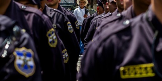 A man looks at a formation of police during a presentation to the press, San Salvador, El Salvador, June 14, 2016 (AP Photo by Salvador Melendez).
