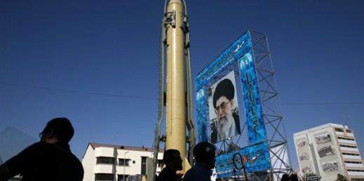 A missile is displayed next to a portrait of Iranian Supreme Leader Ayatollah Ali Khamenei, Tehran, Iran, Sept. 25, 2016 (AP photo by Vahid Salemi).