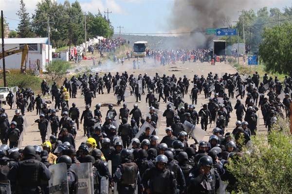 Riot police battling protesting teachers who were blocking a federal highway, Oaxaca, Mexico June 19, 2016 (AP Photo by Luis Alberto Cruz Hernandez).
