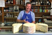 Tim Brown, the owner of the the Melton Cheeseboard, weighs out cheese in his shop in Melton Mowbray, England, Aug. 2, 2016  (AP photo by Jonathan Shenfield).
