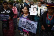 Demonstrators carry messages of support for indigenous women that were victims of sexual violence during Guatemala's civil war, Guatemala City, Feb. 25, 2016 (AP photo by Luis Soto).