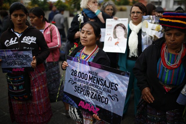 Demonstrators carry messages of support for indigenous women that were victims of sexual violence during Guatemala's civil war, Guatemala City, Feb. 25, 2016 (AP photo by Luis Soto).