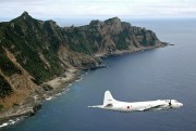 A Japanese Maritime Self-Defense Force surveillance plane flying over the disputed islands, called the Senkaku in Japan and Diaoyu in China, in the East China Sea, Oct. 13, 2011 (Kyodo News photo via AP).