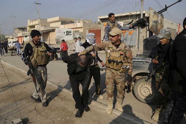 Iraqi security forces arrest a suspected fighter with the Islamic State, Mosul, Iraq, Jan. 4, 2017 (AP photo by Khalid Mohammed).