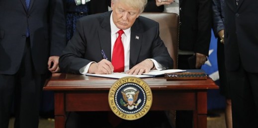 President Donald Trump signs an executive order for border security and immigration at the Department of Homeland Security, Washington, Jan. 25, 2017 (AP photo by Pablo Martinez Monsivais).