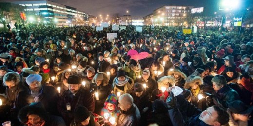 People hold candles for victims of the deadly shooting at a Quebec City mosque, Montreal, Jan. 30, 2017 (The Canadian Press via AP by Ryan Remiorz).