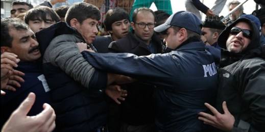 Police scuffle with Afghan migrants as they block the entrance of the Hellenikon migrant camp, Athens, Greece, Feb. 6, 2017 (AP photo by Thanassis Stavrakis).
