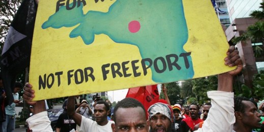A Papuan protester with a poster of a map of Papua province during a demonstration outside the office of Freeport-McMoRan's Indonesian subsidiary, Jakarta, March 1, 2006 (AP photo by Dita Alangkara).
