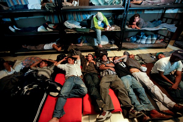 Men look for a place to sleep in a crowded shelter for migrants deported from the United States, Nogales, Mexico. April 28, 2010 (AP photo by Gregory Bull).
