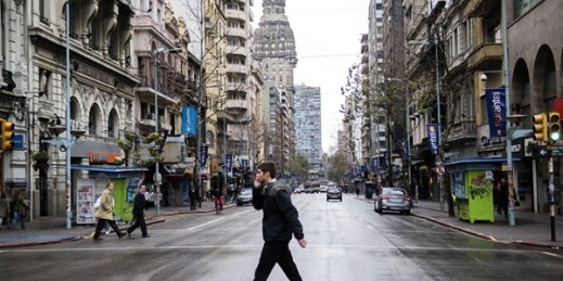 A man crosses a main avenue during a full-day general strike, Montevideo, Uruguay, Aug. 6, 2015 (AP photo by Matilde Campodonico).