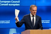 European Council President Donald Tusk holds up the document from the U.K. invoking Article 50 of the EU's Lisbon Treaty, marking the formal start of exit negotiations, Brussels, March 29, 2017 (AP photo by Virginia Mayo).