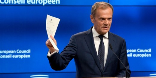 European Council President Donald Tusk holds up the document from the U.K. invoking Article 50 of the EU's Lisbon Treaty, marking the formal start of exit negotiations, Brussels, March 29, 2017 (AP photo by Virginia Mayo).
