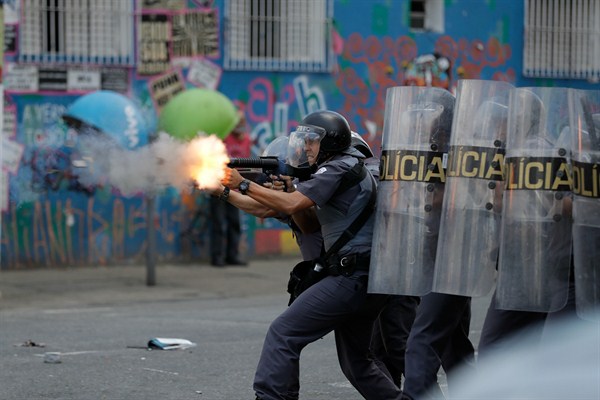 A policeman fires tear gas during a clash with drug offenders, Sao Paulo, Brazil, Feb. 23, 2017 (AP photo by Andre Penner).