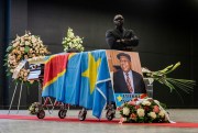 A security guard stands behind the coffin of Congolese opposition icon Etienne Tshisekedi during a service, Brussels, Feb. 5, 2017 (AP photo by Geert Vanden Wijngaert).