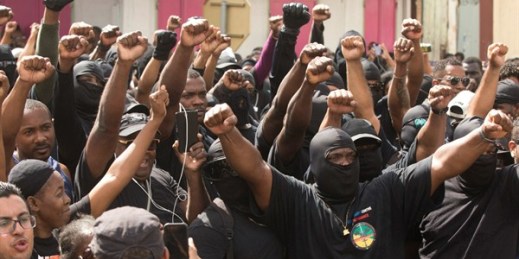 Masked members of the collective "500 Brothers" take part in a march supporting a general strike, Cayenne, French Guiana, March 28, 2017 (AP photo by Pierre-Olivier Jay).