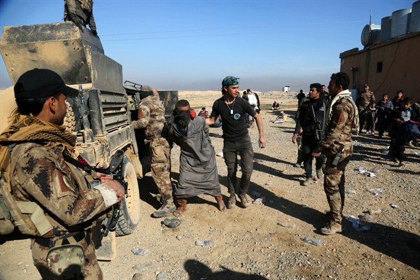 Iraqi special forces arrest a fighter with Islamic State militia, Mosul, Iraq, Feb. 25. 2017 (AP photo by Khalid Mohammed).