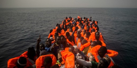 African refugees and migrants, mostly from Sudan and Senegal, wait aboard a rubber boat to be assisted by an NGO, off the Libyan coast, Feb. 23, 2016 (AP photo by Santi Palacios).