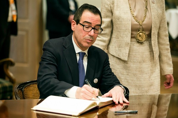 U.S. Treasury Secretary Steven Mnuchin signs the Golden Book of the city during the G20 finance ministers meeting, Baden-Baden, Germany, March 17, 2017 (German Press Agency photo by Christoph Schmidt via AP).