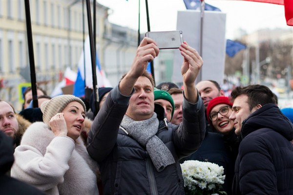 Russian opposition leader Alexey Navalny and his wife, Yulia, take a selfie during a march in memory of opposition leader Boris Nemtsov, Moscow, Russia, Feb. 26, 2017 (AP photo by Ivan Sekretarev).