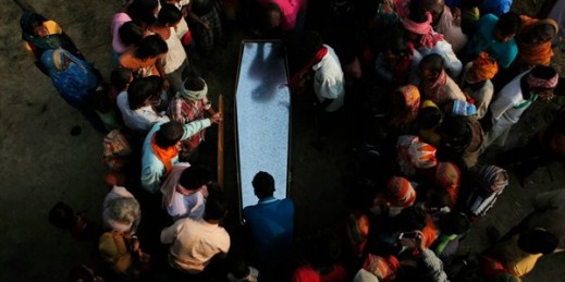 Relatives and villagers gather around the coffin of Balkisun Mandal Khatwe, who died while working as a migrant in Qatar, Saptari, Nepal, Nov. 23, 2016 (AP photo by Niranjan Shrestha).