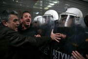 Workers from state hospitals scuffle with the police as they try to break a blockade outside Greece's Finance Ministry, Athens, March 15, 2017 (AP photo by Yorgos Karahalis).