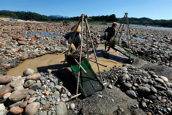 Members of Myanmar's Kachin ethnic group pan for gold in Myitsone, the proposed site of a controversial Chinese-backed dam (AP photo by Khin Maung Win).