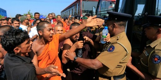 A Buddhist monk and villagers argue with police officers during a protest outside the inauguration ceremony of an industrial zone, Ambalantota, Hambantota district, Sri Lanka, Jan. 7, 2017 (AP photo by Eranga Jayawardena).