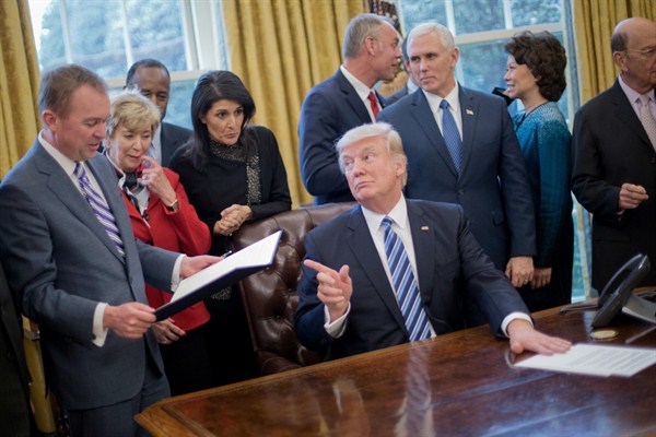 President Donald Trump surrounded by members of his Cabinet in the Oval Office after signing an executive order on reorganizing the executive branch, Washington, March 13, 2017 (AP photo by Pablo Martinez Monsivais).