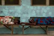 Women sleep on benches outside a hospital, Gabu, Guinea-Bissau, May 21, 2012 (AP photo by Rebecca Blackwell).