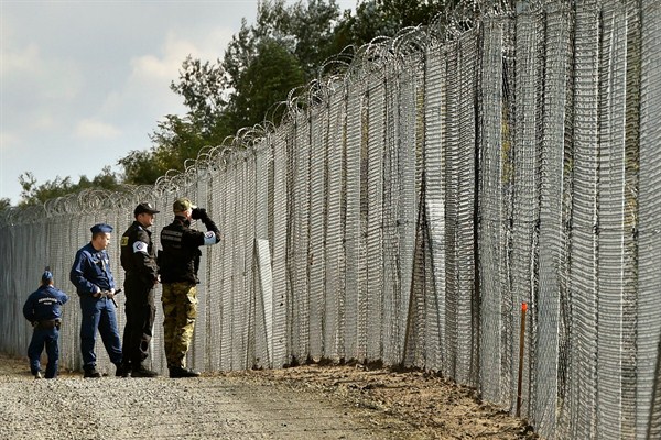 Polish and Hungarian security forces patrol along the temporary border fence on the Hungarian-Serbian border near Roszke, Hungary, Oct. 13, 2016 (AP photo by Zoltan Mathe).