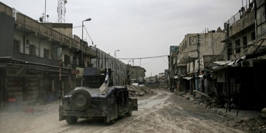 A Humvee belonging to Iraq's federal police drives through an abandoned street in western Mosul, Iraq, May 2, 2017 (AP photo by Bram Janssen).