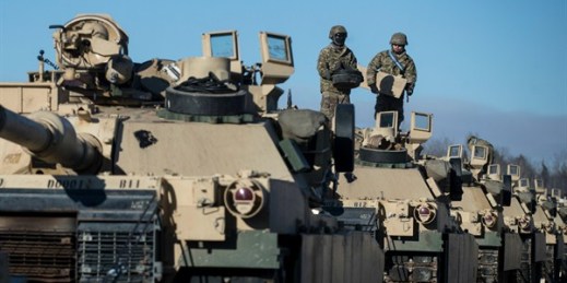 Members of the U.S. Army's 4th Infantry Division prepare to unload Abrams tanks after arriving at the Gaiziunai railway station, west of the capital, Vilnius, Lithuania, Feb. 10, 2017 (AP photo by Mindaugas Kulbis).