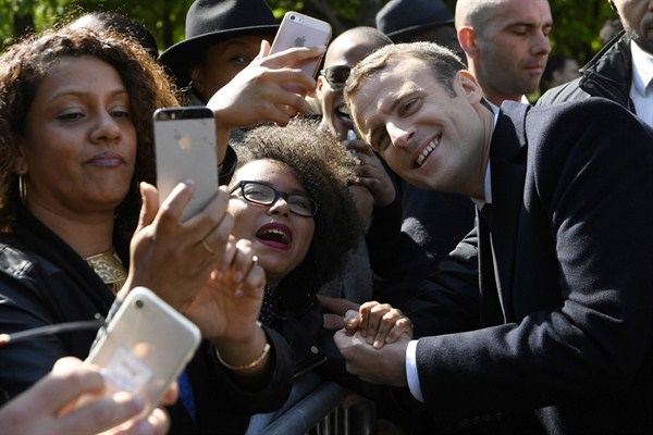 President-elect Emmanuel Macron poses for a picture with supporters after a ceremony to mark the anniversary of the abolition of slavery, Paris, May 10, 2017 (Pool photo by Eric Feferberg via AP).