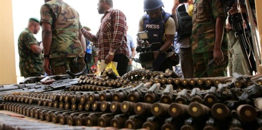 Journalists look at arms and ammunition which military commanders say they seized from Islamic fighters, Maiduguri, Nigeria, June 5, 2013 (AP photo by Jon Gambrell)