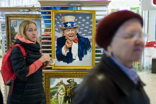 People walk past a caricature picture of U.S. President Donald Trump on sale in a shopping mall in Moscow, Russia, May 17, 2017 (AP photo by Alexander Zemlianichenko).