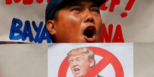 A protester shouts while displaying an anti-Donald Trump placard during a rally at the U.S. Embassy in the Philippines to coincide with Trump's inauguration, Manila, Jan. 20, 2017 (AP photo by Bullit Marquez).