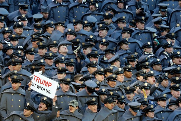 An Army Cadet displays a sign for then President-elect Donald Trump during the Army-Navy NCAA college football game, Baltimore, Saturday, Dec. 10, 2016 (AP photo by Patrick Semansky).